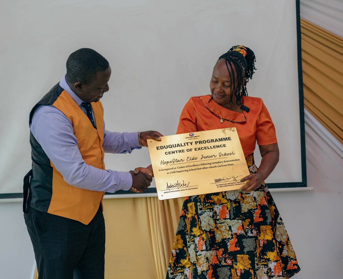 Selina receives an award plaque on behalf of her school in recognition of its achievements. Photo by: Nathaniel Abadji / Opportunity EduFinance